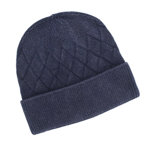 Close-up of navy blue knit beanie showing diamond cable stitch pattern and ribbed cuff