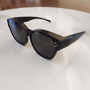 Detail of matte black TR90 polarized kids sunglasses with classic triple dot studs