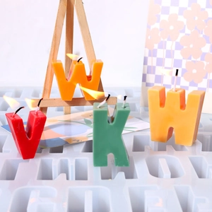 Detailed view of colorful burning alphabet candles with a silicone DIY craft mold