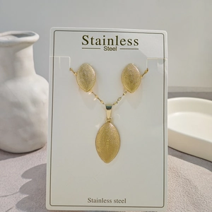 Vintage geometric stainless steel jewelry set with textured oval earrings and necklace