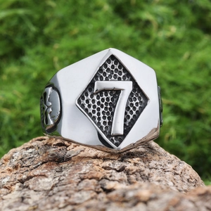 Men's punk skull lucky number 7 stainless steel ring on natural bark background