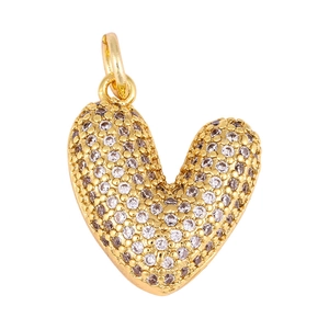 Macro shot of 3D heart-shaped gold charm pendant with sparkling micro-inlaid crystals