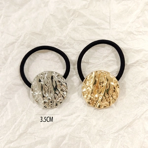 Detail of 3.5cm hollow round hammered metal hair ties in gold and silver finish