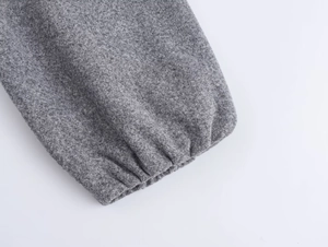 Detailed macro view of elastic ribbed cuffs on a heather gray fleece bomber jacket
