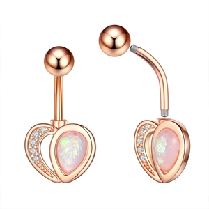 Detail of rose gold heart belly ring with pink opal and zircon pavé on white background