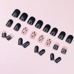 Short black and pink press-on nails with crown patterns and silver glitter accents
