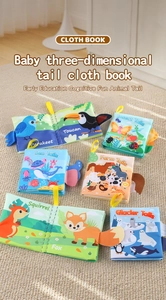 Set of six baby sensory cloth books featuring 3D animal tails on a soft beige rug