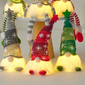 Light-up Christmas gnomes with knitted hats and warm glowing bodies for holiday decor