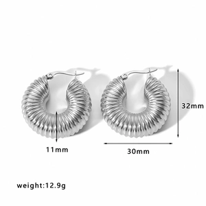 Detailed view of silver spiral textured hoop earrings with dimensions 32mm and 30mm