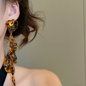Close-up of leopard print acrylic petal tassel earrings with long drop design