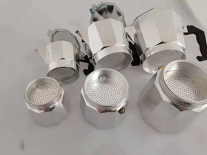 Various sizes of octagonal aluminum moka pot components on a clean white background