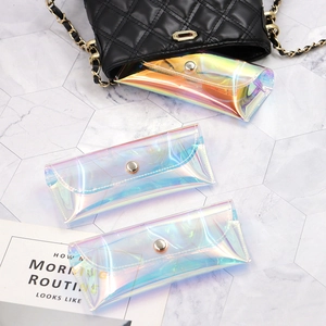 Iridescent PVC glasses pouch set with metallic snap button on white marble background