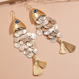 Golden fish-shaped shell earrings with evil eye detail for a seaside vacation look