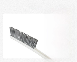 Detail of long-handle gap brush with dense grey elastic bristles for narrow cleaning