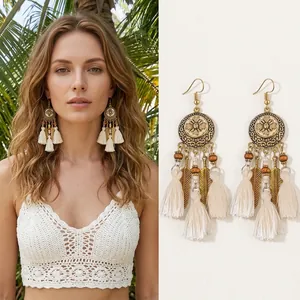 Detail view of Bohemian tassel earrings with metallic feathers and woven beads