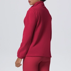 Detail view of the stand-up collar and elastic cuffs on a dark red fleece sports jacket