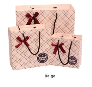 Three-piece beige gift bags set with dark grey check pattern and red ribbon bows