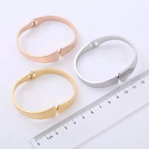 Polished stainless steel spring bangles in gold, silver and rose gold with size ruler