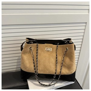 Detail of khaki suede tote bag featuring quilted pattern and woven chain strap