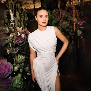Elegant white one-shoulder dress with ruched detail and high slit for summer fashion