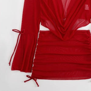 Detail of red mesh two-piece cover-up set with tie-cuffs and drawstring mini skirt