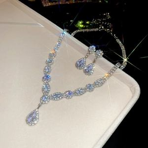 Macro view of water-drop zircon necklace and earrings set on velvet display