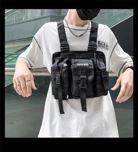 Detail view of black tactical chest rig with multi-pocket design and adjustable straps