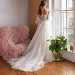 Elegant white off-shoulder lace wedding dress with puff sleeves and long mesh skirt