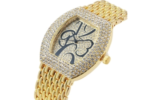 Detailed close-up of gold quartz watch with sparkling rhinestones and artistic numerals