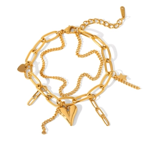 Detail of layered paperclip chain bracelet with heart and star charms in gold finish