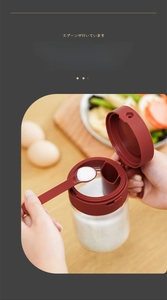 Detail of integrated spoon and lid design on glass spice jar for easy one-hand operation