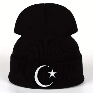 Close-up of black beanie featuring high-quality white moon and star embroidery detail