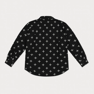 Detailed close-up of black cotton shirt fabric featuring all-over white cross flower print