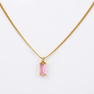 Macro detail of 18K gold snake chain with a rectangular pink zircon stone pendant