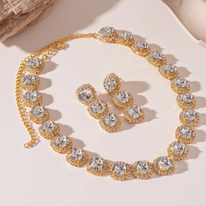 Macro detail of gold-plated halo jewelry set with round crystals and pavé diamonds
