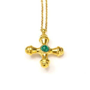 Macro detail of 18k gold plated titanium cross pendant with inlaid green malachite stone