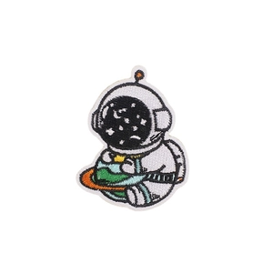 Embroidered cartoon astronaut holding a planet patch for clothing and decoration