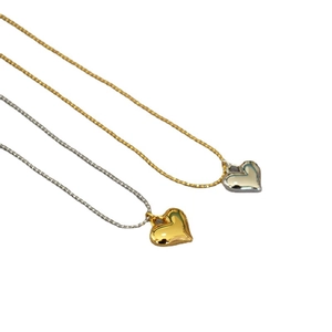 Minimalist gold and silver heart pendant necklaces on delicate bead chains with mirror polish