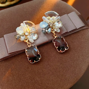 Elegant vintage gold earrings with flower crystal studs and purple rectangular gemstone