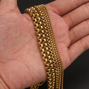 Five widths of polished gold stainless steel box chains displayed on a palm