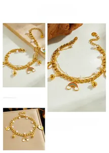 Detail of gold double-layer chain bracelet with enamel rainbow and pearl charms