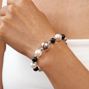 Close-up of beaded bracelet with faux pearls and silver metal beads on a wrist