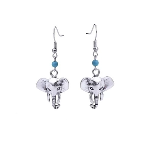Macro detail of antique silver elephant earrings with intricate engraved patterns and blue beads