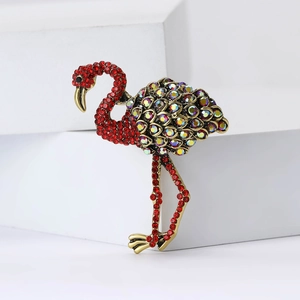 Elegant bronze flamingo brooch with vibrant red and AB rainbow rhinestones on white background