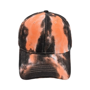 Close-up of the orange and black tie-dye texture and stitching on the baseball cap