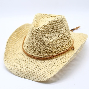 Detail of hollow-out breathable weave and brown braided band on beige straw cowboy hat
