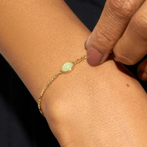 Minimalist gold Figaro chain bracelet with a light green oval natural aventurine stone