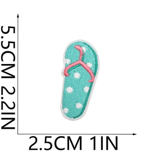 Detail showing embroidered flip-flop patch with blue polka dots and size measurements