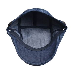 Detailed interior of denim flat cap showing inner lining, stitching and side metal buckle