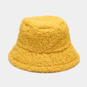 Close-up of bright yellow sherpa bucket hat with thick fleece texture for winter warmth
